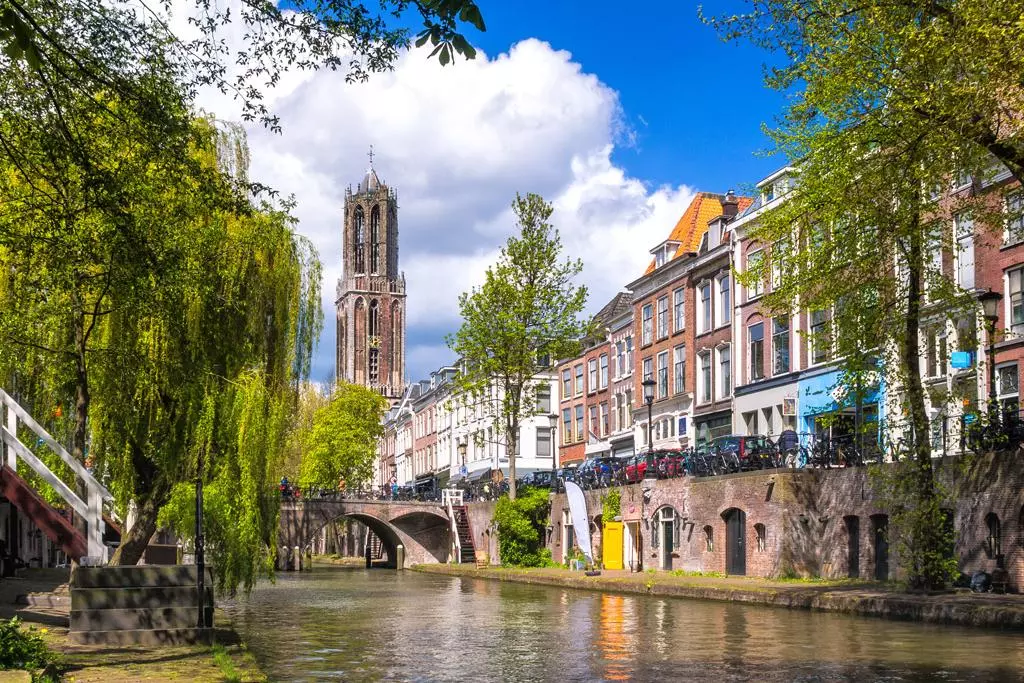 the oudegracht canal in the old center of utrecht with the domtoren churchtower